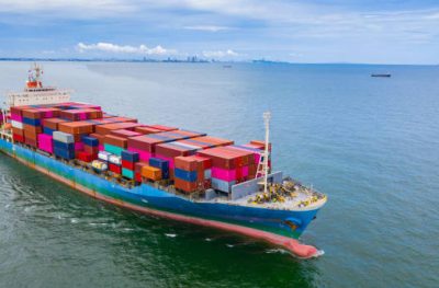 Aerial view container ship carrying container in import export business logistic and transportation of international by container ship in the open sea.